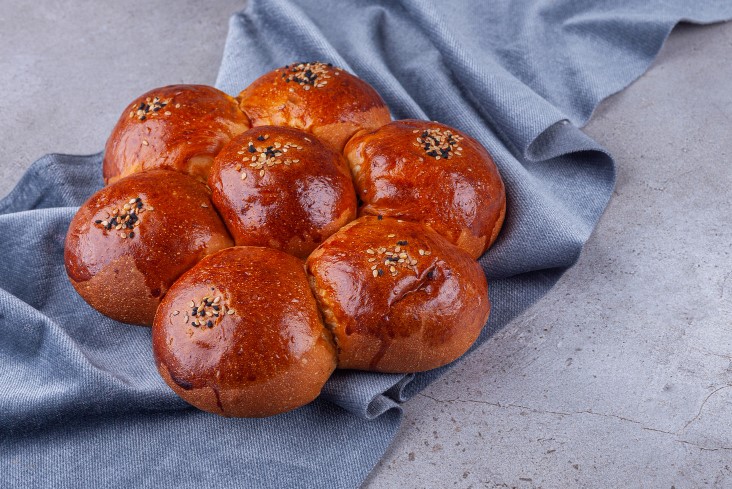 sweet-bun-with-sesame-seeds-placed-on-a-stone-background.jpg