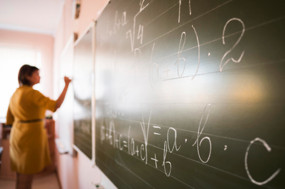 portrait-teacher-writing-on-chalkboard.jpg