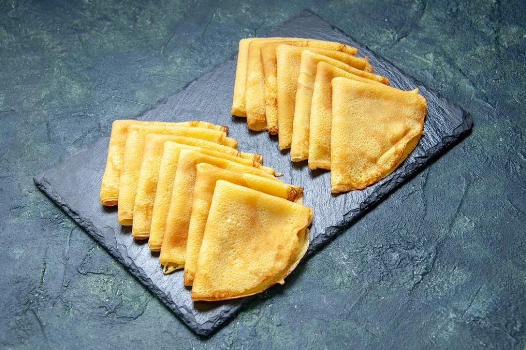 front-view-delicious-pancakes-on-dark-blue-color-pastry-bake-oven-pie-cake-dough-breakfast-meat_179666-43752.jpg
