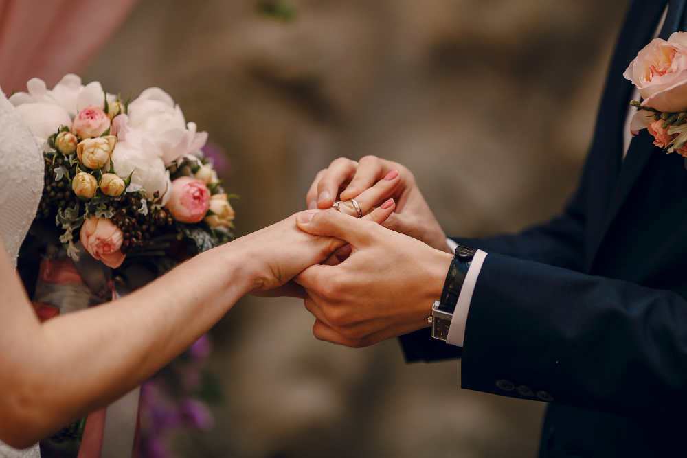 groom-putting-ring-on-bride-s-finger.jpg