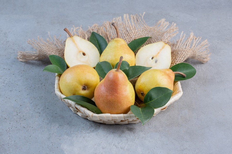 delicious-pears-and-decorative-leaves-in-a-small-basket-on-marble-background.jpg